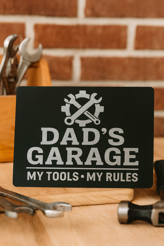 Customizable decorative plaque measuring 7x5" with Dad's Garage shop engraving, "My Tools, My Rules" as the personalized text, in front of a brick background with shop tools