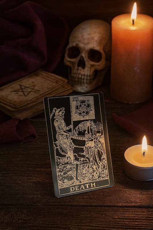 Tarot card labeled 'Death' with candles and skull on a wooden surface