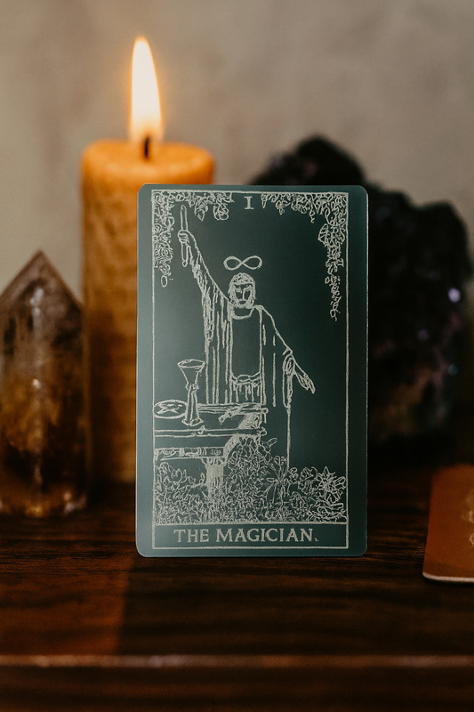 Tarot metal keepsake card titled 'The Magician' with a candle and crystal ball in the background