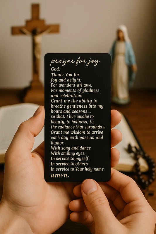 Person holding a prayer card with a cross and statue in the background