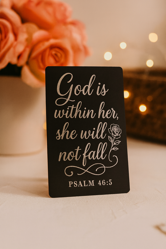Metal business card with motivational quote pictured in front of roses