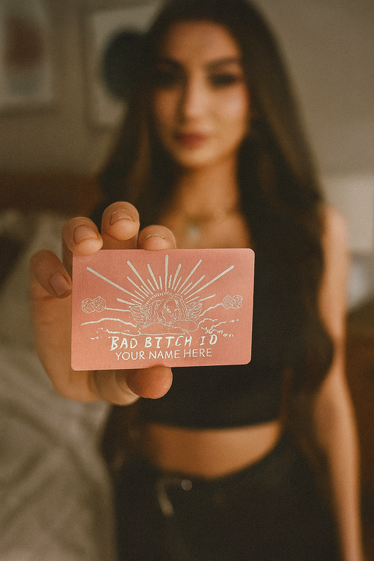 Person holding a pink card with text and graphics, blurred background