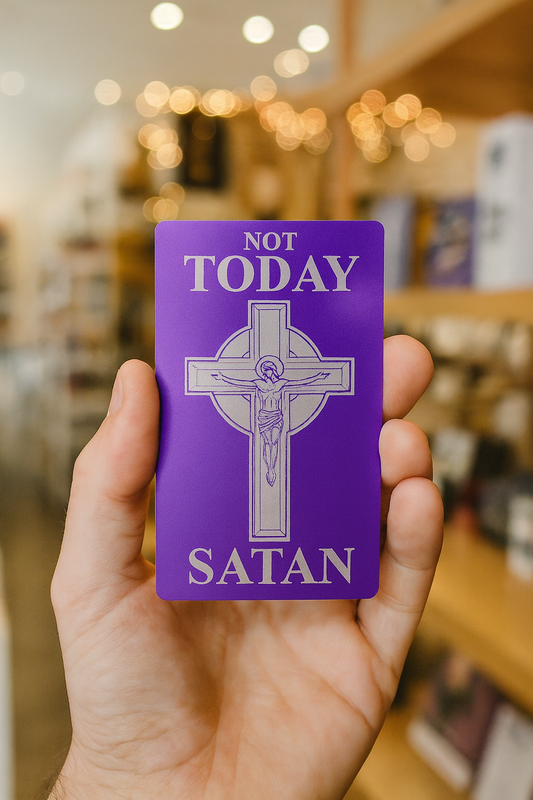 Purple metal card with cross design and text held by a hand in a store setting