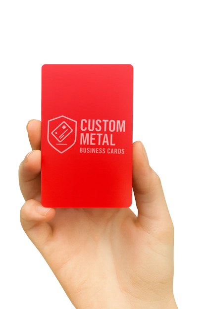 Hand holding a red card with 'Custom Metal Business Cards' text on a white background
