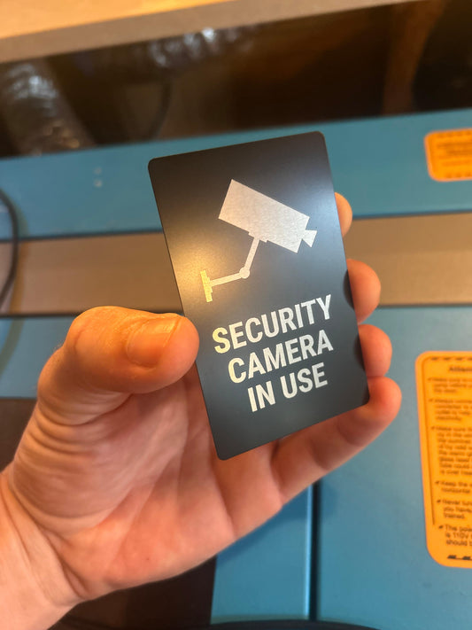 Metal "Security Camera In Use" metal placard in black/silver