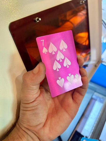 Laser engraved metal poker card with 7 of spades laser engraved in purple/silver