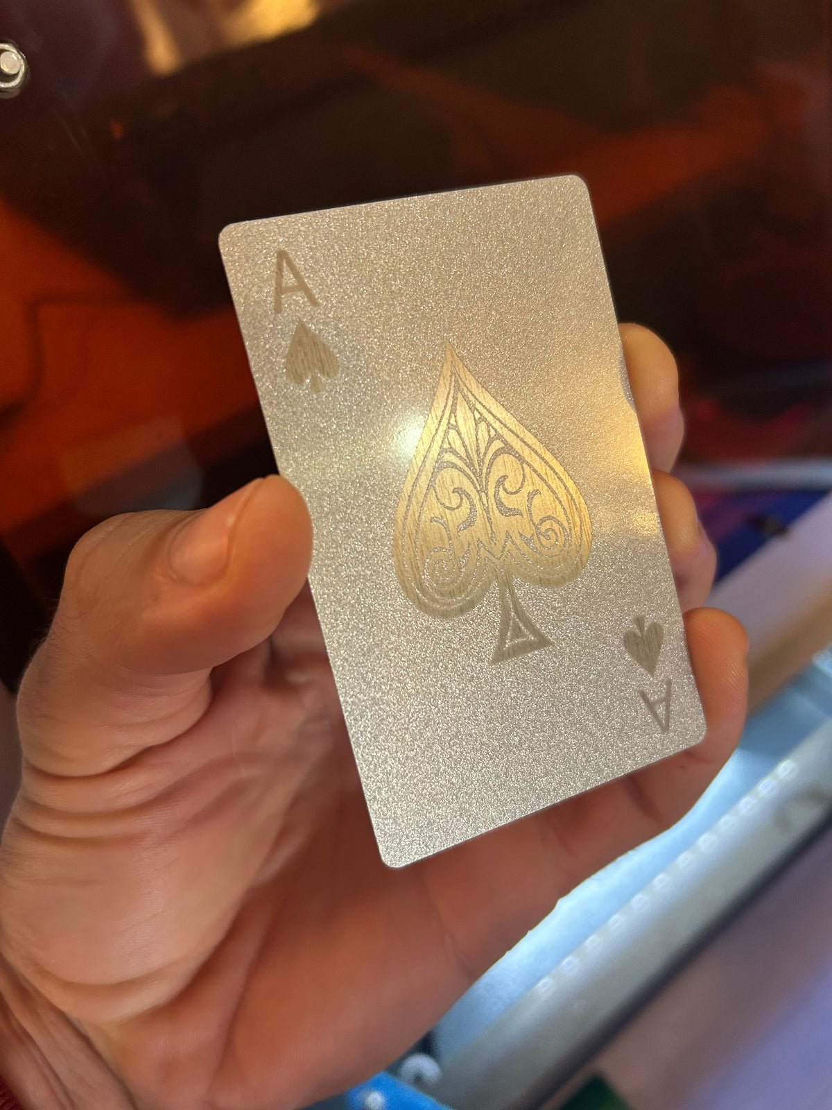 Metal playing card with ace of spades engraving