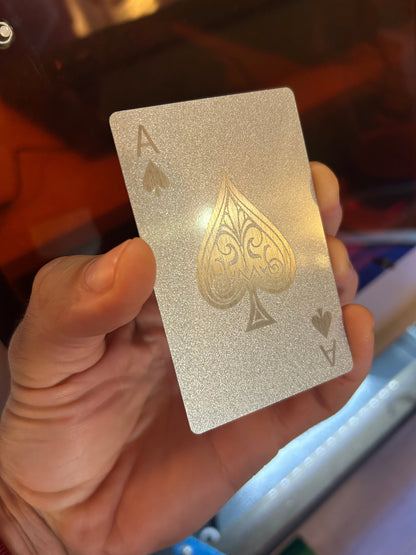 Metal playing card with ace of spades engraving
