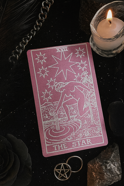 Rose gold/silver tarot card titled 'The Star' with a candle and pentacle on a dark background
