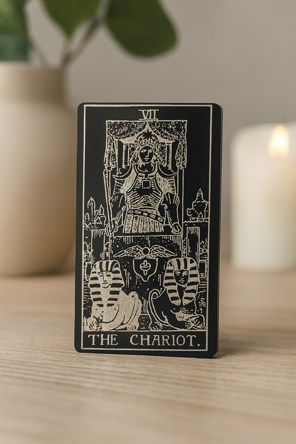Tarot metal gift card featuring 'The Chariot' design on a wooden surface with a blurred background
