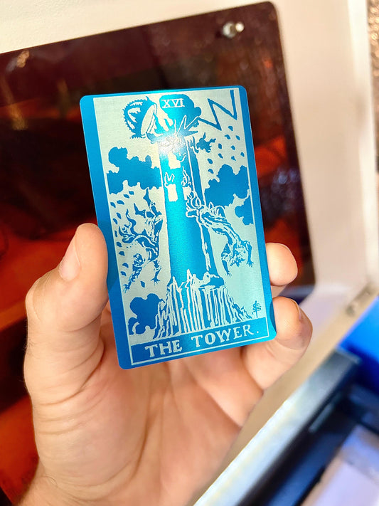 Metal The Tower tarot card laser engraved in blue/silver anodized aluminum