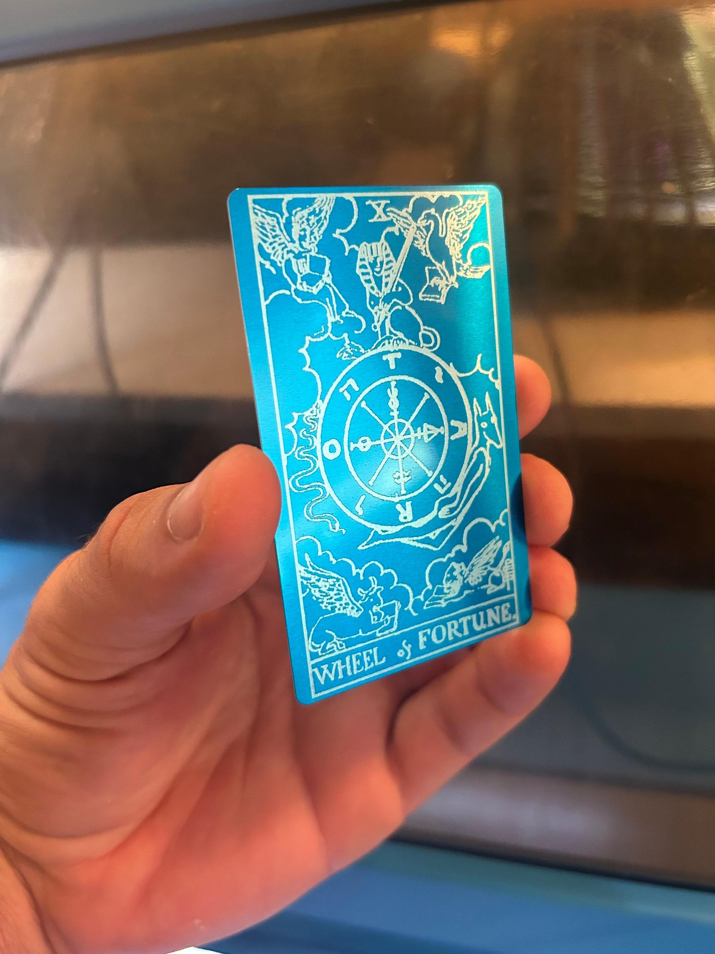 Metal Wheel of Fortune tarot card in blue/silver anodized aluminum