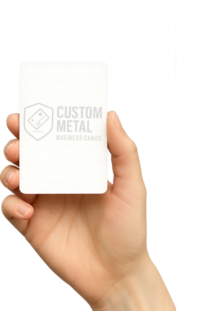 Hand holding a white business card with 'Custom Metal' branding on a white background